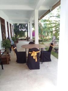 a table and chairs with a yellow bow on it at Waterway garden in Polonnaruwa