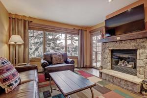 a living room with a couch and a fireplace at Mountain Thunder M1101 in Breckenridge