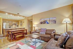 a living room with a couch and a table at Mountain Thunder M1101 in Breckenridge