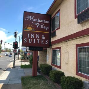 a sign for a inn and suites on the side of a building at Manhattan Inn & Suites in Manhattan Beach