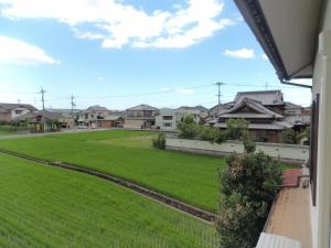 a view of a green yard with houses at Konpira House in Kotohira