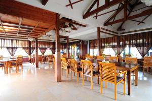 a dining room with wooden tables and chairs at Dago Highland Resort in Bandung