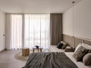 A bed or beds in a room at Olea All Suite Hotel, a Member of Design Hotels
