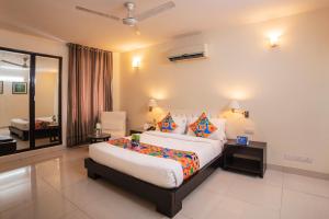 a bedroom with a large bed in a room at FabExpress Anutham Saket in New Delhi