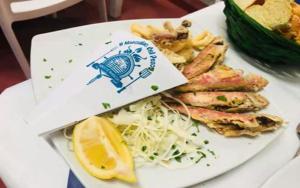 a plate of food with a lemon on it at La Casa Dei Delfini in Lampedusa