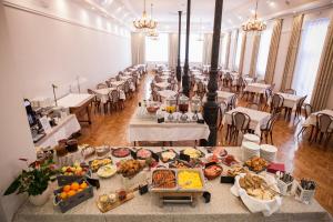 a large banquet hall with tables filled with food at ECO Hotel Center in Postojna