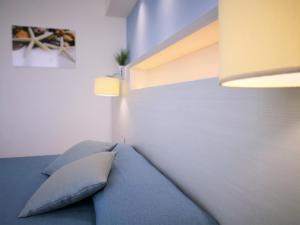 a bed with two pillows on it in a room at Hotel Perla Gaia in San Vito lo Capo