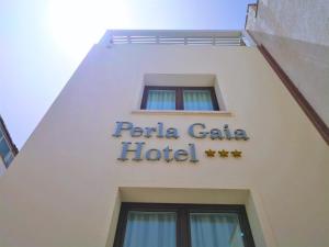 a hotel sign on the side of a building at Hotel Perla Gaia in San Vito lo Capo
