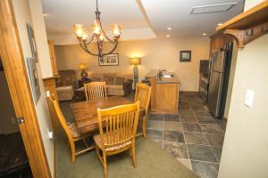 a kitchen and dining room with a table and chairs at Sundial Lodge Condo Steps from Red Pine Gondola in Park City