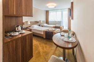 Postel nebo postele na pokoji v ubytování Hotel Polanica Resort & Spa
