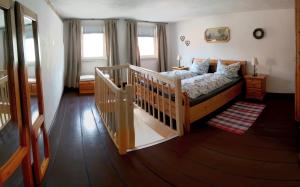 a bedroom with a bed and two windows at Ferienwohnungen zur Post - 102 in Weidenberg