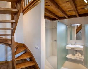 a bathroom with a staircase and a shower and a sink at Somo Garden Villas in Somo