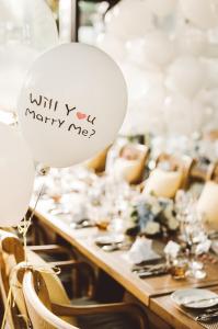 a table with a balloon with a marry me sign on it at Na Nirand Romantic Boutique Resort in Chiang Mai
