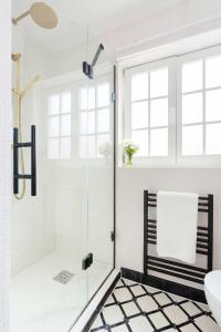 a bathroom with a shower with a glass door at Veeve - Revitalising in Kensal Rise in London