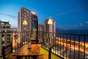 a balcony with a table and a view of the city at Nhat Minh Hotel and Apartment in Da Nang