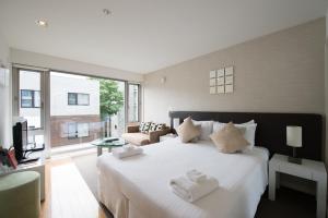 A bed or beds in a room at Niseko Central Condominiums