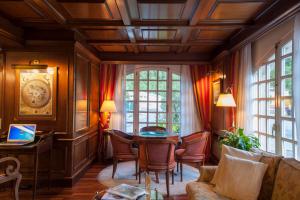 a living room with a table and chairs at Hotel Edelweiss in Camprodon