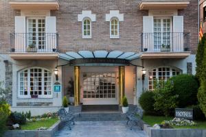 a brick building with a entrance to a store at Hotel Edelweiss in Camprodon