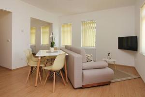 a living room with a couch and a table at Boutique Apartments in Hévíz