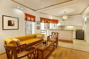 a living room with a couch and a table at The Pinewood, Nainital by Leisure Hotels in Nainital