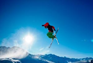 a man flying through the air while riding skis at Haus Ladner in See