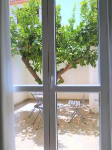 a window view of a table and chairs outside at Hotel Perla Gaia in San Vito lo Capo