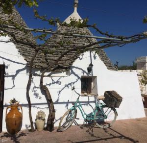 a blue bike parked next to a white building at Trullo Cicerone in Martina Franca