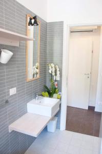 a bathroom with a sink and a mirror at Milò casa vacanze in Cupra Marittima