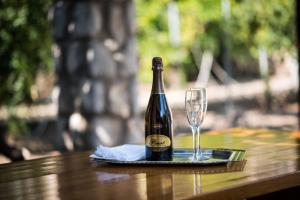 a bottle of champagne and a glass on a table at apartman Babić in Krk