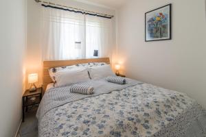 a bedroom with a bed with two pillows on it at apartman Babić in Krk +19 photos