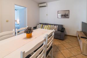 a living room with a table and a couch at apartman Babić in Krk