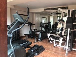 a gym with several treadmills and exercise machines at The Siam Heritage Hotel in Bangkok