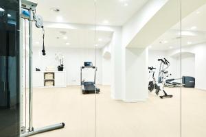 a gym with treadmills and elliptical machines at Eurostars Ibiza in Ibiza Town