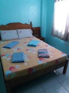 a bed in a room with towels on it at Eco Pension in Surigao