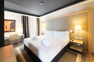 Tempat tidur dalam kamar di Hotel Jazz