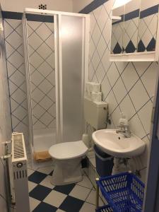a bathroom with a toilet and a sink at Zita Haus in Bük