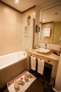 a bathroom with a sink and a bath tub at Kenzi Club Agdal Medina - All Inclusive in Marrakech