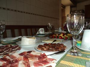 a table with plates of food and wine glasses at Casa Villar Mayor in Vilar Maior