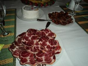 a table with a plate of food on a table at Casa Villar Mayor in Vilar Maior