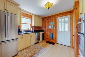 a kitchen with wooden walls and wooden floors and a refrigerator at Necessary Escape in York