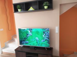 a flat screen tv sitting on a stand in a room at Globus Gran Alacant in Santa Pola