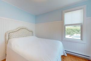 a bedroom with a white bed and a window at Necessary Escape in York