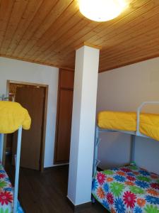 two bunk beds in a room with a wooden ceiling at Sol Mar in Odeceixe