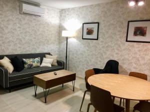 a living room with a couch and a table at Puerta Trujillo in Plasencia