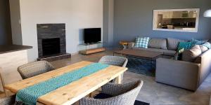 a living room with a couch and a table with chairs at Vista Mare in Swakopmund