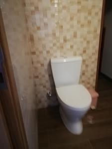 a bathroom with a white toilet in a room at Sol Mar in Odeceixe