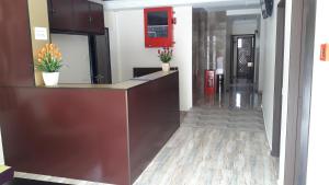 a lobby with a counter with flowers on it at TULIP HOTEL & APARTMENT in Cameron Highlands