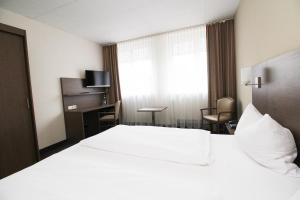 Postel nebo postele na pokoji v ubytování Hotel Berliner Ring