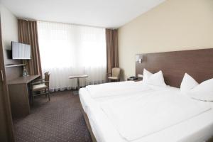 Postel nebo postele na pokoji v ubytování Hotel Berliner Ring