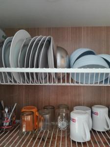 a shelf with plates and dishes in a kitchen at Anni Apartment in Tallinn